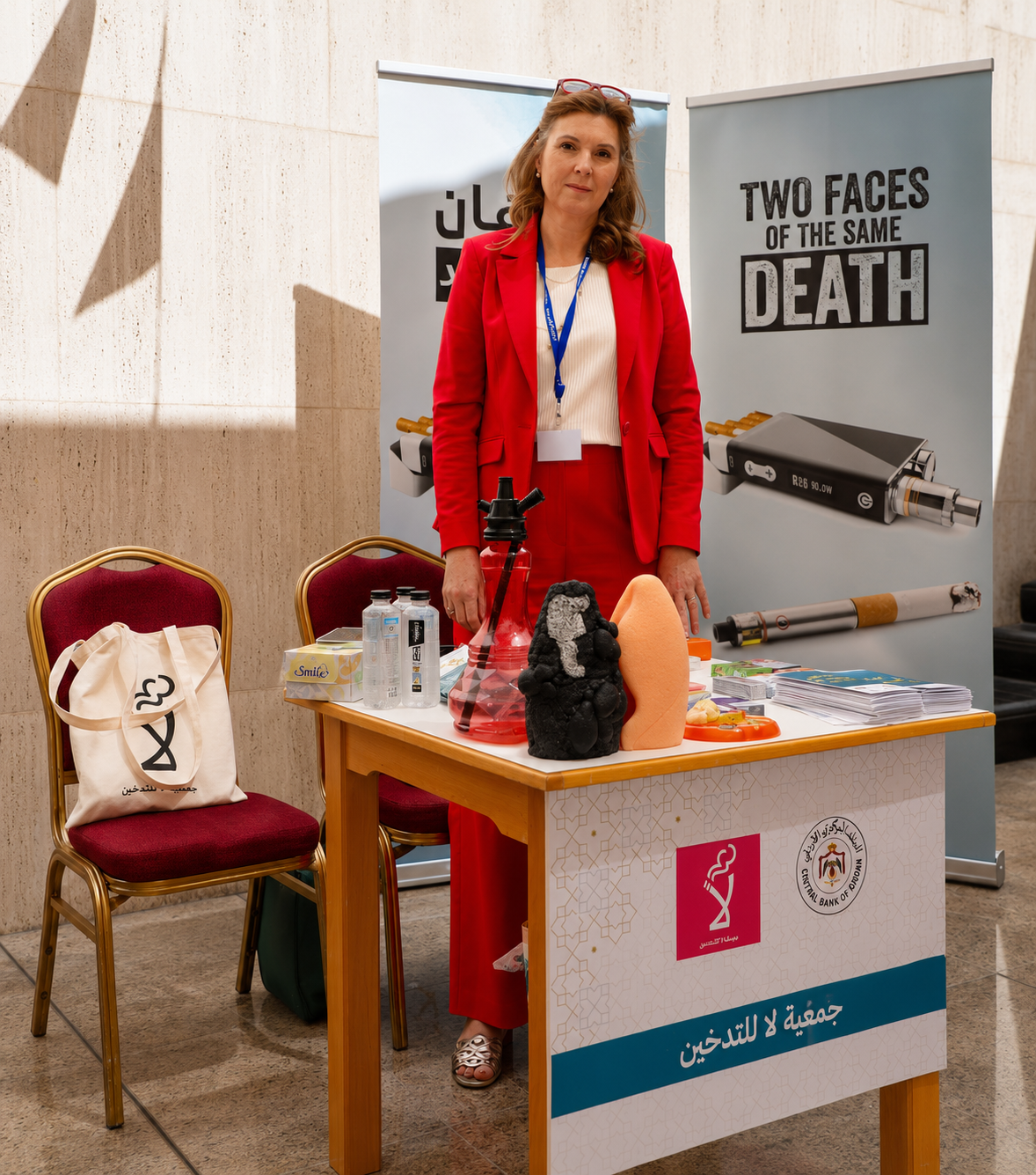A Tobacco Free Jordan representative in a red suit at an awareness stand